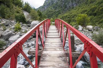 Fototapeta na wymiar Red bridge in Grunas Canyon, Theth, Albania