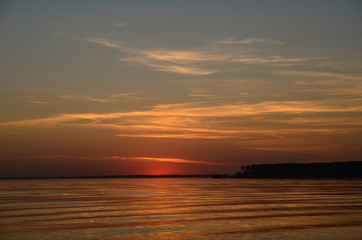Beautiful sunset on the river and sky near the forest