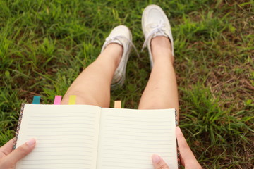 Woman open book or grass.