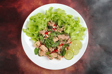 Spicy and sour mixed vegetable salad with canned tuna served .
