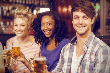 Composite image of portrait of cheerful friends having beer