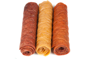 Candied fruit twisted in roll isolated on white background. Homemade sweetness of dried fruit.