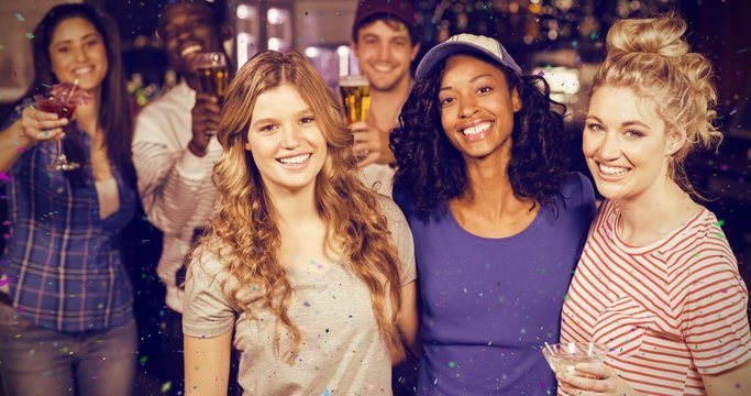 Composite image of portrait of smiling friends having beer