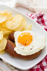 fried portuguese sausage alheira with egg and potato chips