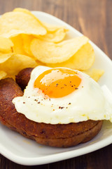 fried portuguese sausage alheira with egg and potato chips