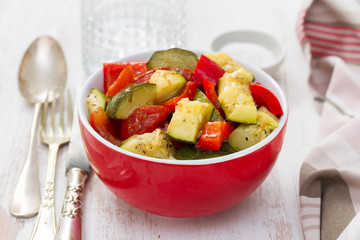 vegetables in red bowl on wooden background