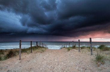 stormy sunset over beach in North sea