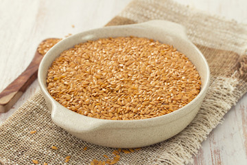 seeds on white dish on wooden background