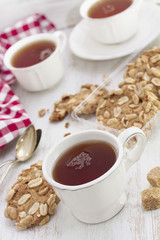 cup of tea with cookies on wooden background