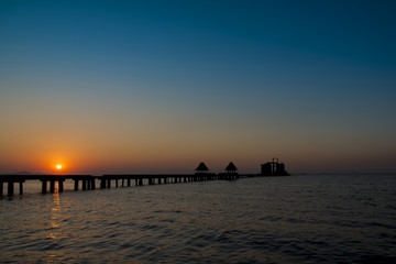 Fototapeta na wymiar Sunset with sea and long bridge, thailand