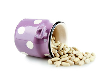 Grain white beans in a decorative bucket.