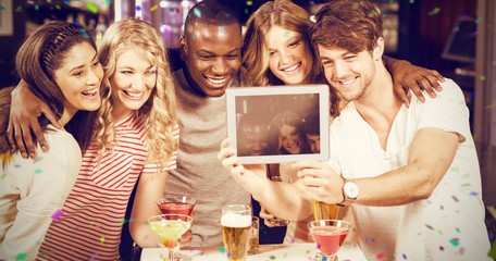 Composite image of happy friends taking selfie with tablet