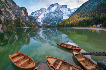 Fototapeta premium Magical autumn landscape with boats on the lake on Fanes-Sennes-