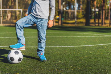 Child playing football on court