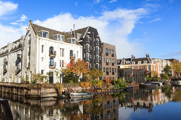 Fototapeta na wymiar Beautiful view of canals in autumn sunny day, Amsterdam, Netherlands 