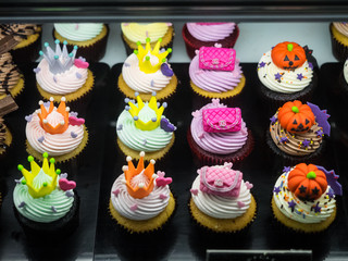 Fancy halloween cupcakes with pumpkins, bags and crowns