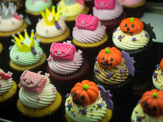 Fancy halloween cupcakes with pumpkins, bags and crowns