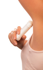 Unidentified woman uses dry underarm deodorant isolated on white.