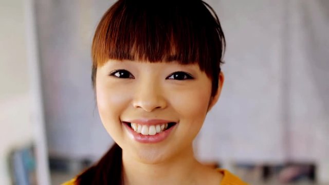 face of happy smiling asian young woman
