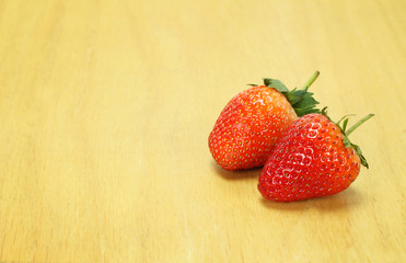 Fresh red strawberries on wooden table