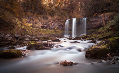 The Afon Hepste river plunges over a band of resistant gritstone to form the waterfall Sgwd yr Eira which translates into 'Fall of snow' and often refered to as the waterfall you can walk under.