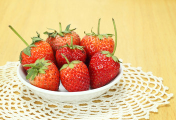Fresh red strawberries on wooden table