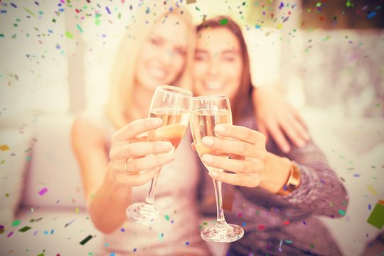Composite image of beautiful women toasting champagne flute