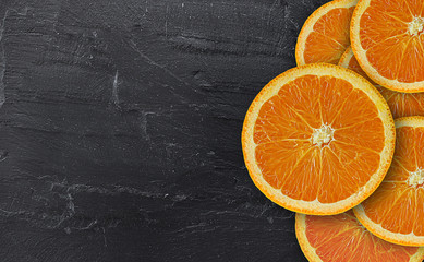 orange fresh cut on black stone. focus on orange fresh cut. with copy space for your text 