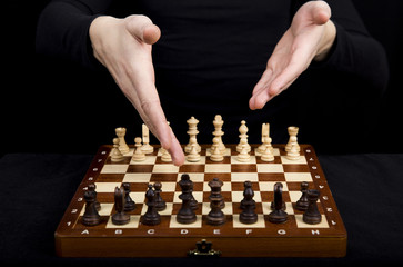 closeup beautiful hands point to the opponent chess pieces on wo