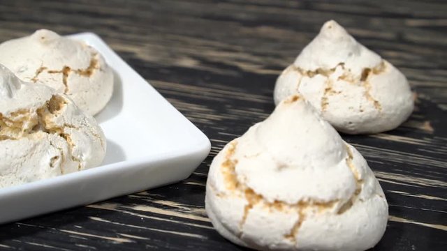 lot of white meringue cakes with coffee