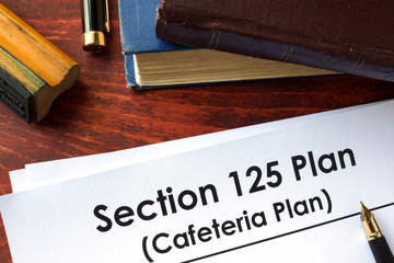 Papers with Section 125 Plan (Cafeteria Plan) on a table.