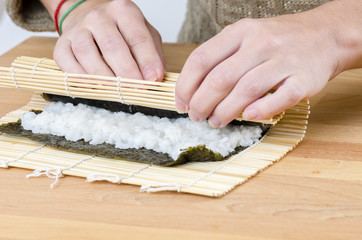 Woman is making rolls in her kitchen