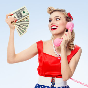 woman with money, talking on phone, dressed in pin-up style dres