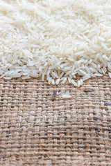 rice grains on old sack background. over light [blur and select focus background]
