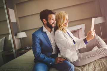 Couple on business trip using tablet