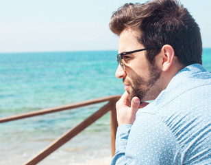Fototapeta premium young man thinking in the beach