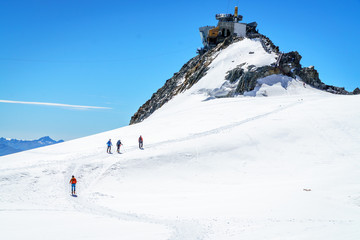 Mountaineers walking on the summit of Mont Blanc