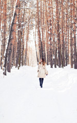 Girl walking in snow. Winter, cold and people concept