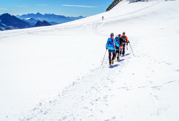 Fototapeta na wymiar Mountaineers walking on the summit of Mont Blanc