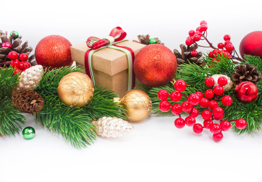 Christmas or New Year background: fur-tree, branches, gifts, colored glass balls, decoration and cones on a white background