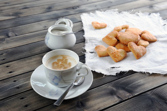 Foods of the Italian breakfast with coffee milk and biscuits on an old wooden table