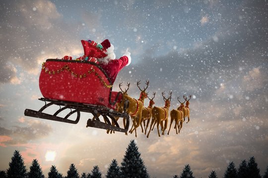 Composite image of santa claus riding on sleigh with gift box
