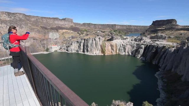 Backpacker Girl Taking Pictures with her Smartphone Shoshone Falls Idaho