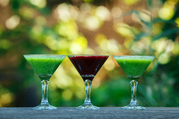 fresh cocktail in martini glass on wooden board. bokeh background.