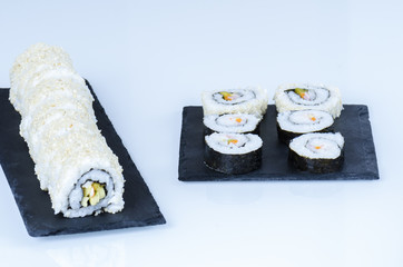 Maki sushi, rolls on slate plate.