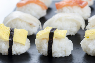 Sushi nigiri set on slate plate.