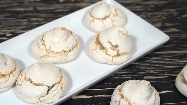 lot of white meringue cakes with tea.