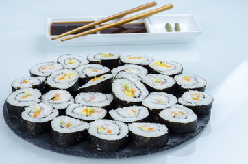 Maki sushi, rolls on slate plate.