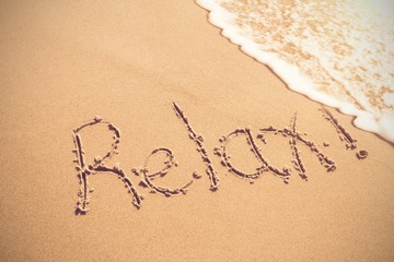 Relax written on sand