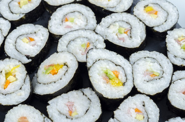 Maki sushi, rolls on slate plate.